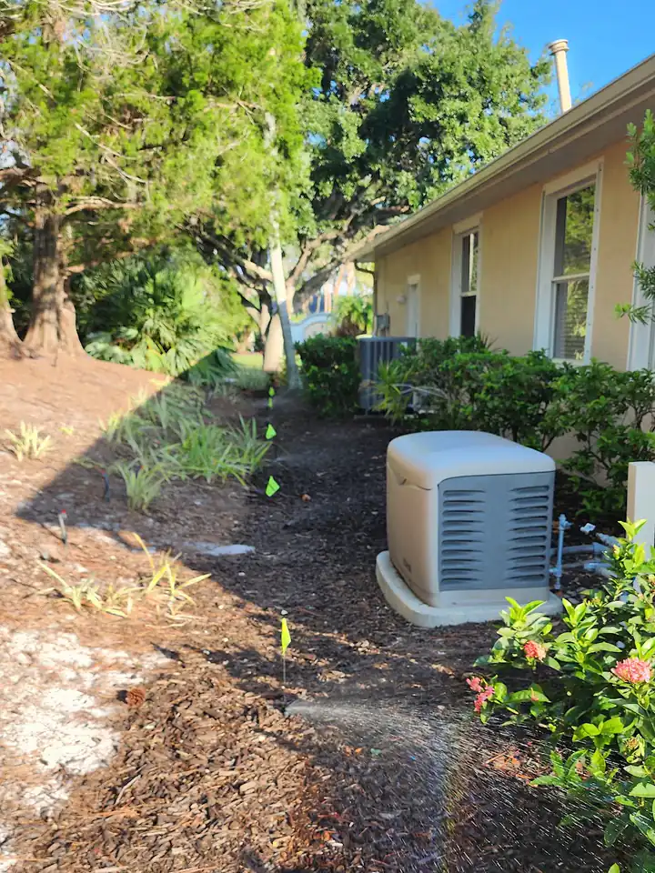 Sprinkler zone running across a mulched side yard, Lakewood Ranch
