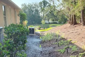 Irrigation running along a mulched bed beside a home, Lakewood Ranch
