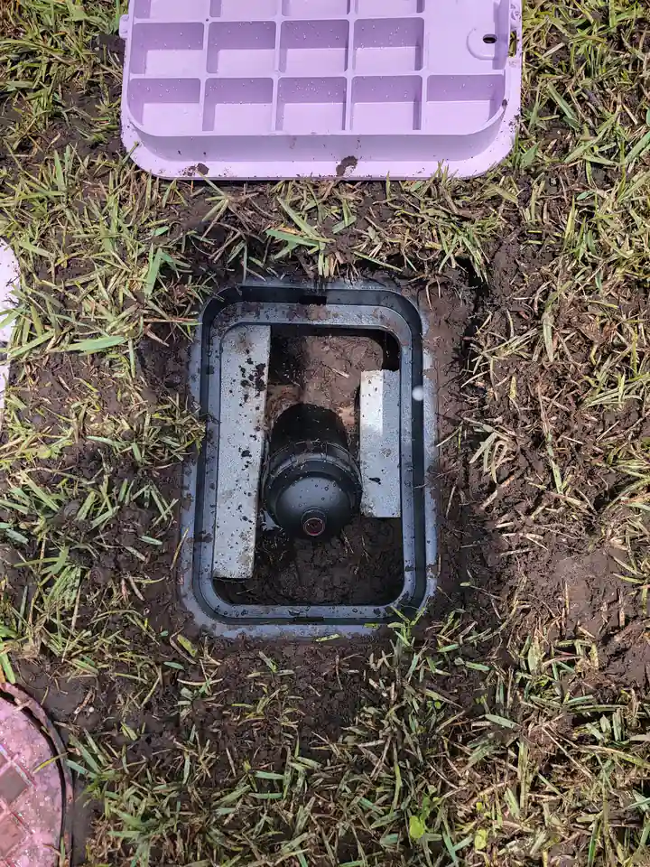 Irrigation valve inside an opened valve box in a lawn, Bradenton